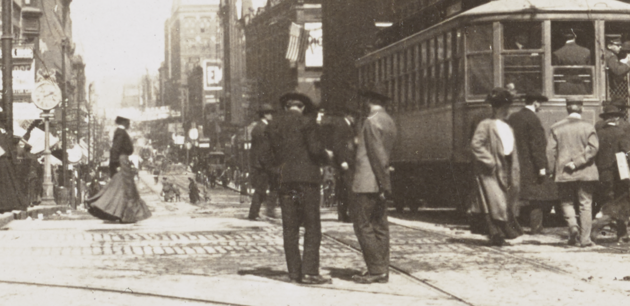 Seventh Street from Wabasha, St. Paul, Minn. Summary: People standing on street and curb; streetcar at right. 
